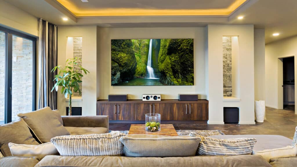 Luxury home theater with large screen, plush seating, and modern decor.